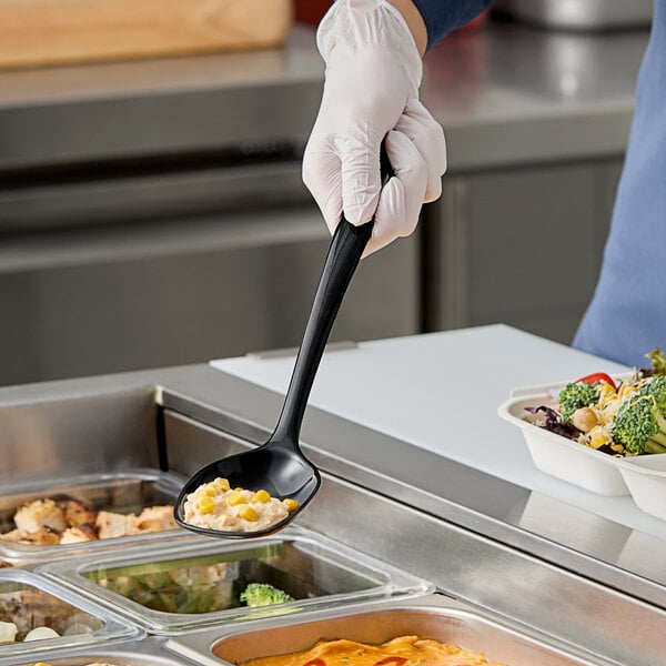 A person holding a black Elite Global Solutions spoon of food.
