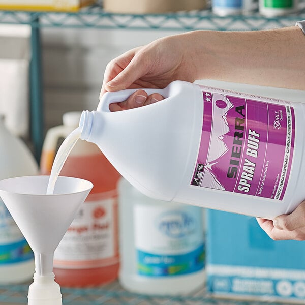 A person pouring Sierra by Noble Chemical spray buff restorer into a white bowl.