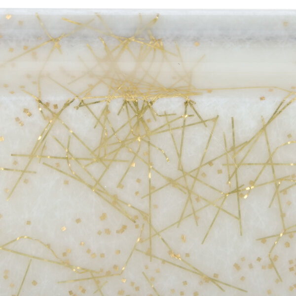 A white rectangular surface with gold lines.