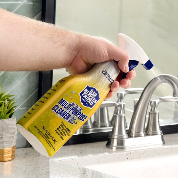 A bottle of Bar Keepers Friend 25.4 oz. all purpose spray foam cleaner being used to clean a bathroom sink.