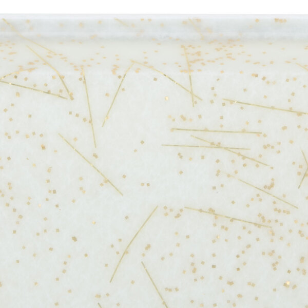 A white surface with gold sparkles.