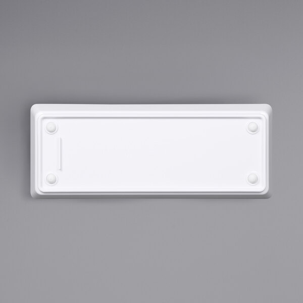 A white rectangular melamine bowl with a black border.