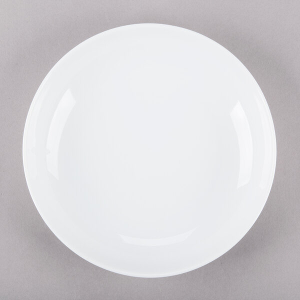 A white porcelain soup bowl with a white rim on a gray surface.