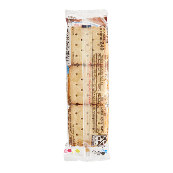A white and blue package of Lance Nekot vanilla cookies with a close-up of a cookie with holes in it.