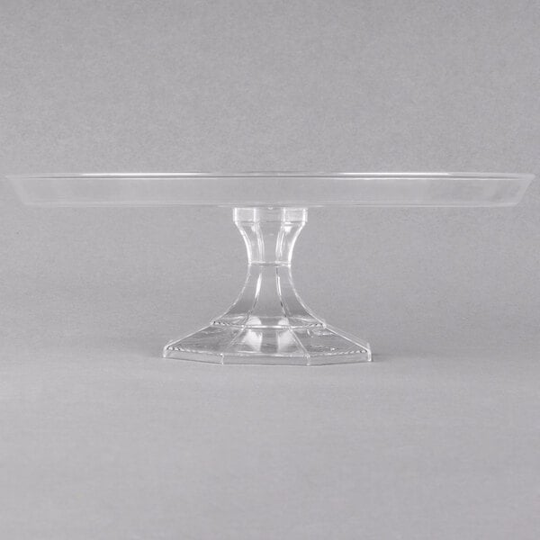 A clear plastic cake stand with a clear base.