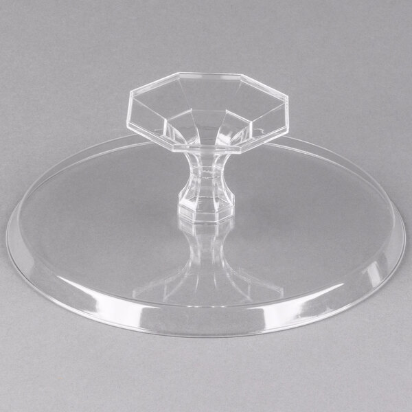 A clear plastic Fineline cake stand with a clear hexagonal base.