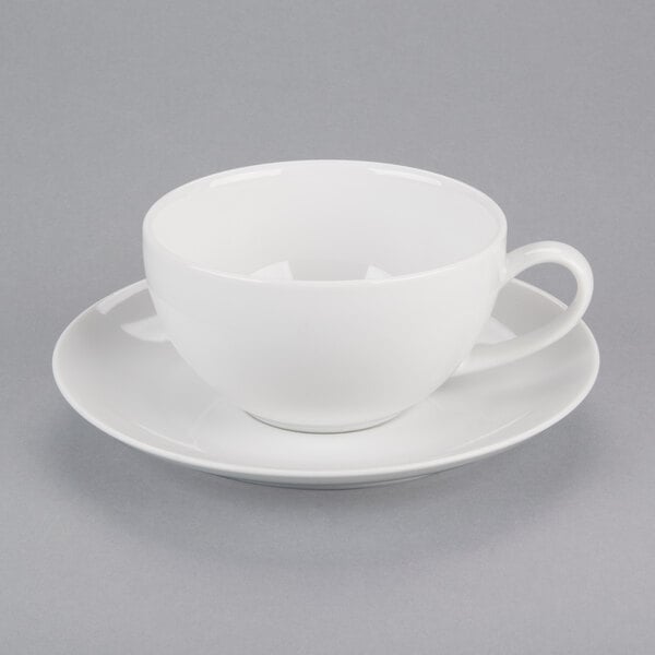 A 10 Strawberry Street Royal Coupe white porcelain cup and saucer on a white surface.