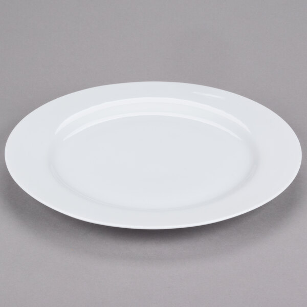 A 10 Strawberry Street classic white porcelain charger plate with a rim on a gray surface.