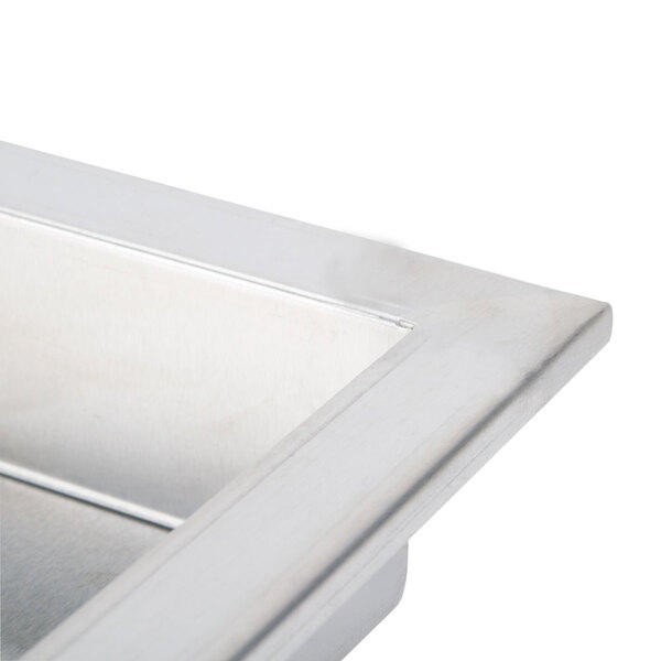 A stainless steel cover on a countertop fryer.