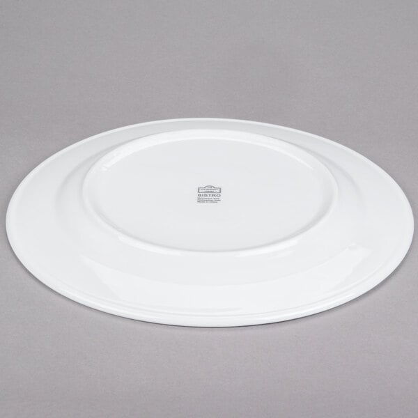 A 10 Strawberry Street Bistro round white porcelain charger plate.