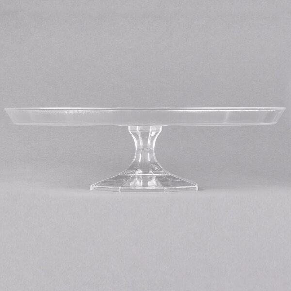 A Fineline clear plastic cake stand with a base.