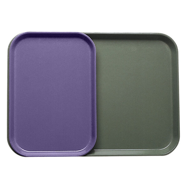 Two purple Cambro trays with a purple lid on a counter.