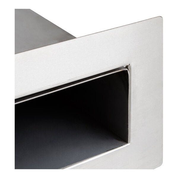 A close-up view of a rectangular stainless steel vent duct with a brushed finish.