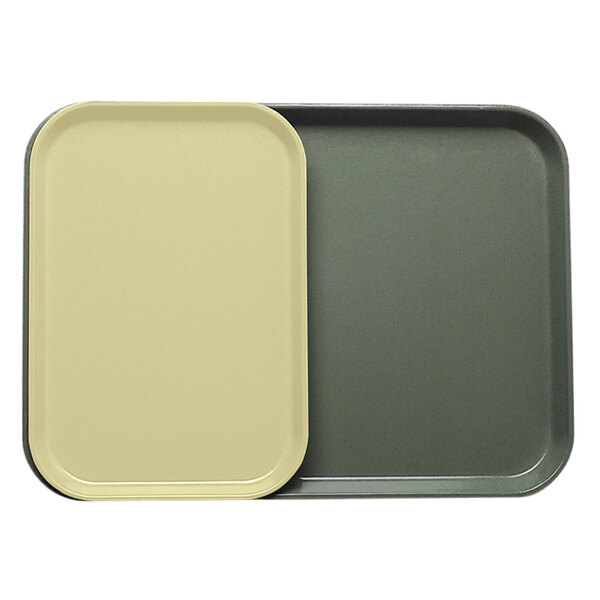 A close-up of a grey rectangular Cambro tray insert with yellow and green sides.