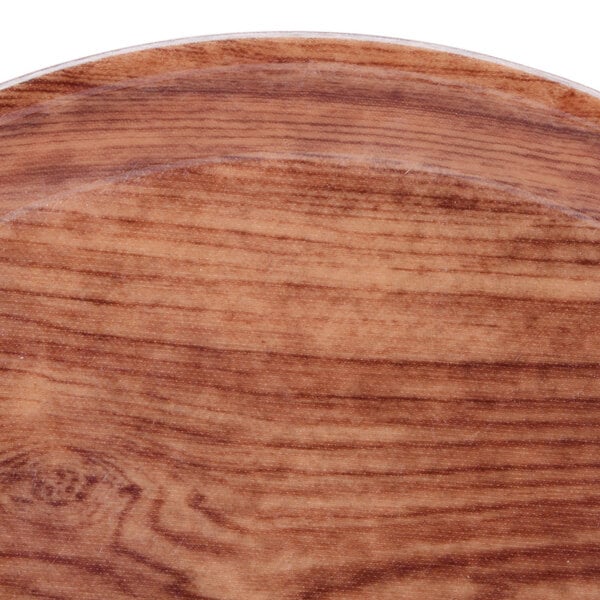 A close up of a Java teak wood plate with a brown rim.