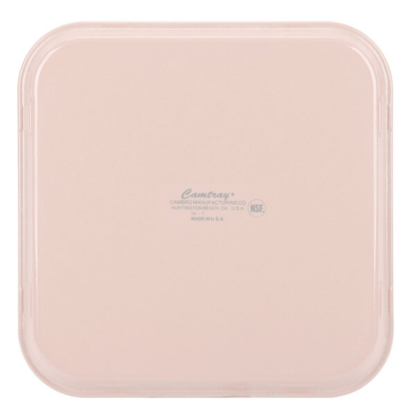A square light peach Cambro container with a label.