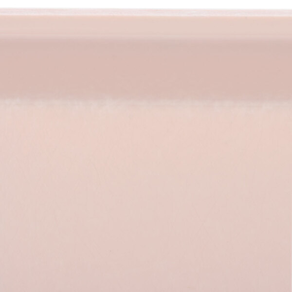 A close-up of a light peach square Cambro tray surface.