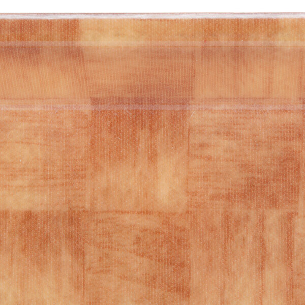 A wood surface with a brown Cambro square basketweave tray.