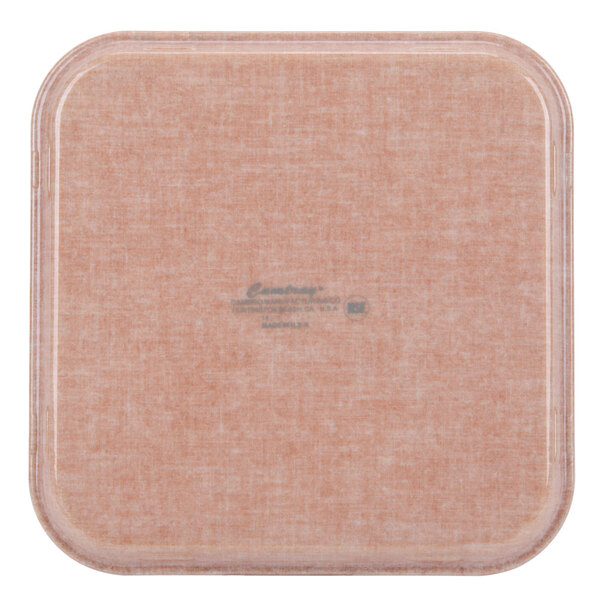 A square Cambro fiberglass tray with a square design on a table.