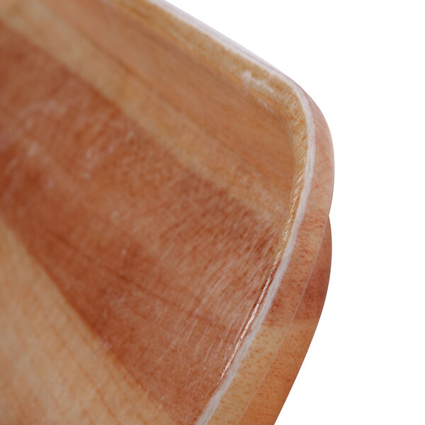 A close up of a rectangular wooden Cambro tray with handles.