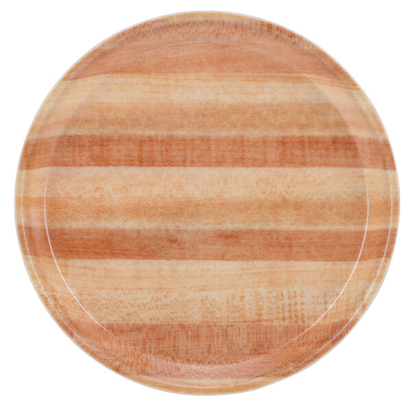 A close up of a Cambro round butcher block tray with a striped pattern.