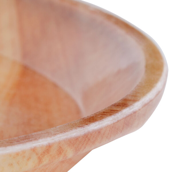 A close-up of a Cambro fiberglass tray with a wooden butcher block design.