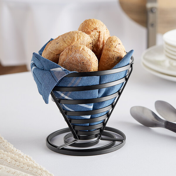 An American Metalcraft wrought iron cone basket with a napkin-lined croissant inside.