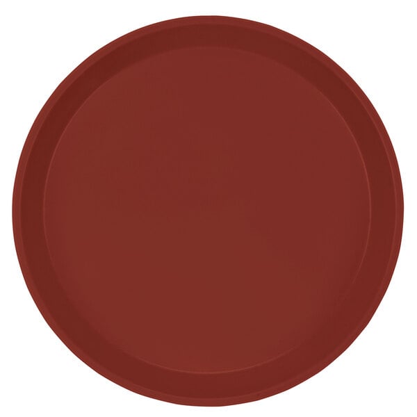 A red round Cambro fiberglass tray with a white border.