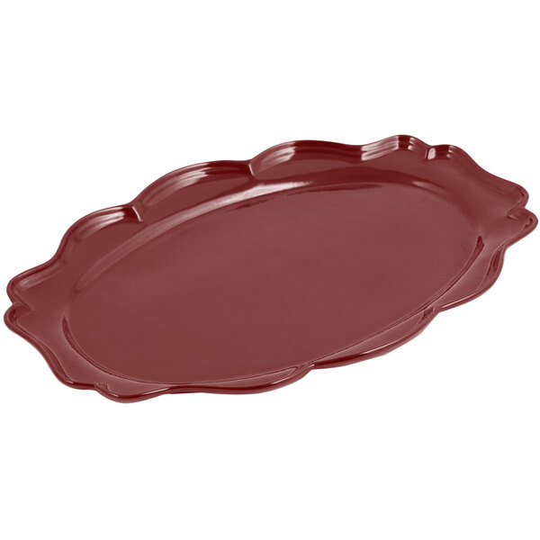 A red Bon Chef cast aluminum oval platter with a scalloped edge.