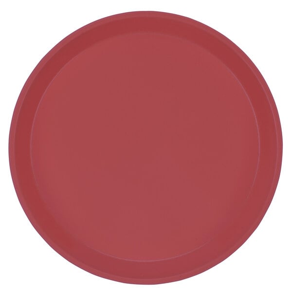 A red Cambro round fiberglass tray with white lines.