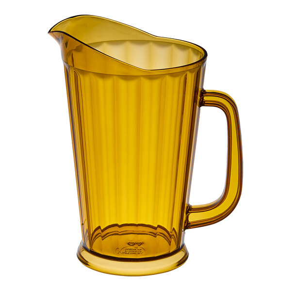 A yellow pitcher with a handle.