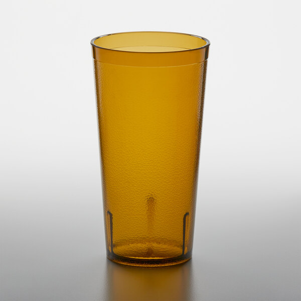 An amber GET plastic tumbler on a table.