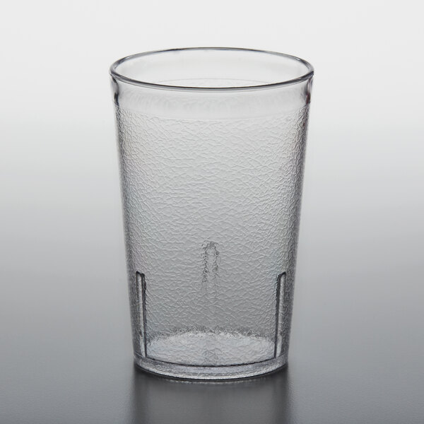 A close-up of a clear plastic pebbled tumbler.