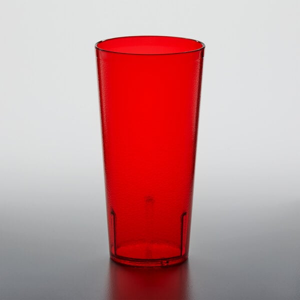 A red plastic GET tumbler on a white surface.
