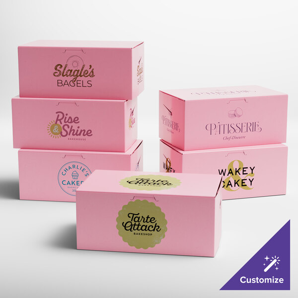 A group of pink customizable bakery boxes on a table.