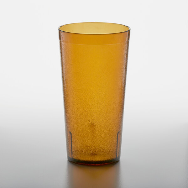 A brown GET plastic tumbler with a straw.