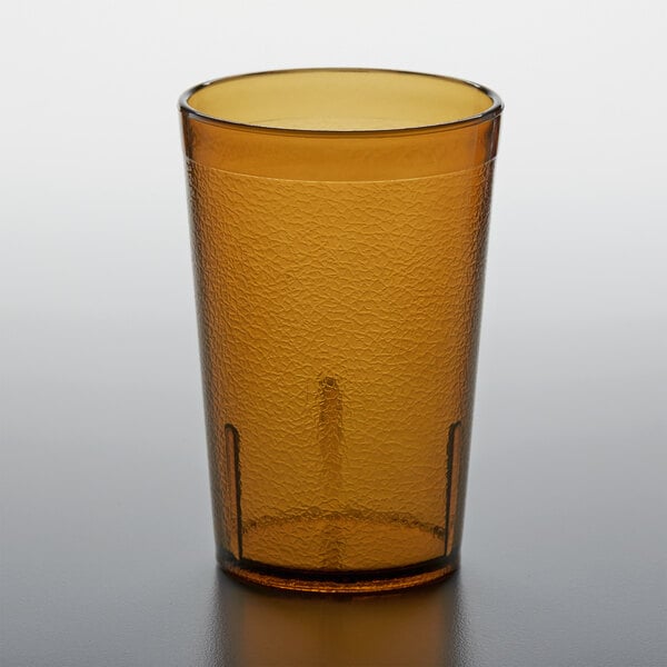 A brown GET plastic tumbler on a table.