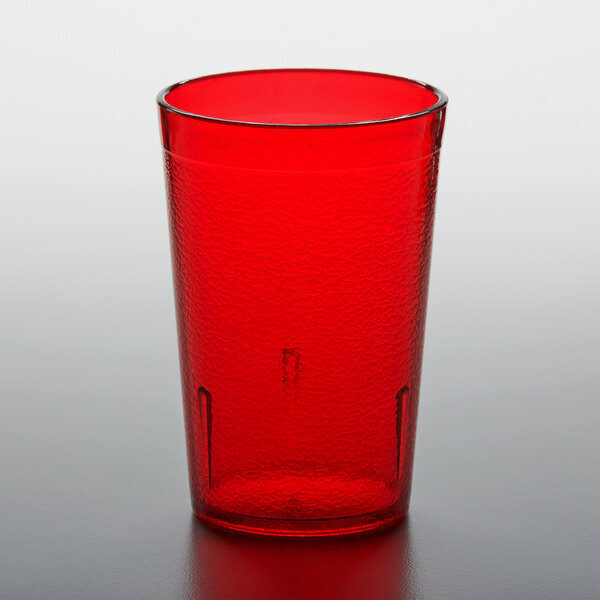 A red plastic GET tumbler on a gray surface.