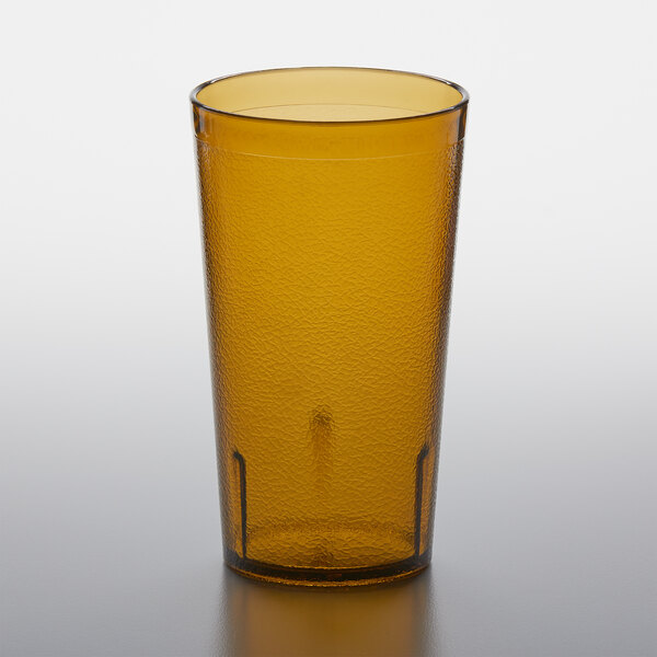 An amber GET plastic tumbler on a table.