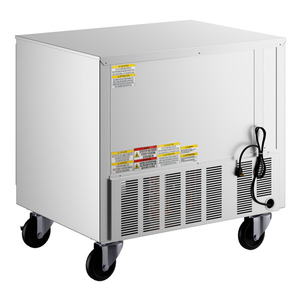 A stainless steel undercounter freezer on wheels with a vented panel and power cord.