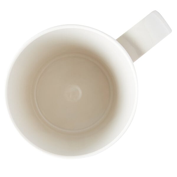 A close-up of a white Carlisle Tritan mug with a handle.