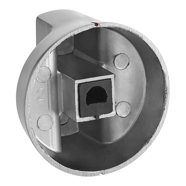 A stainless steel dial with a hole in the center.