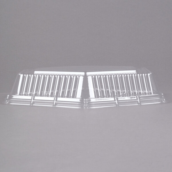 A clear plastic Genpak Smart-Set hexagonal lid on a metal surface.