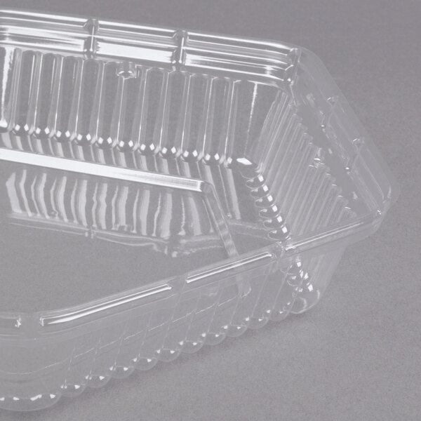 A Genpak clear hexagonal dome lid on a clear plastic container.