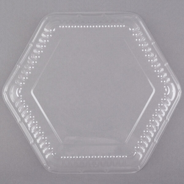 A Genpak clear hexagonal plastic lid with holes.