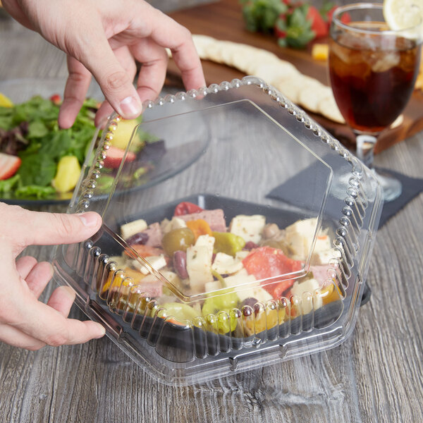a close-up of a hand holding a plastic container
