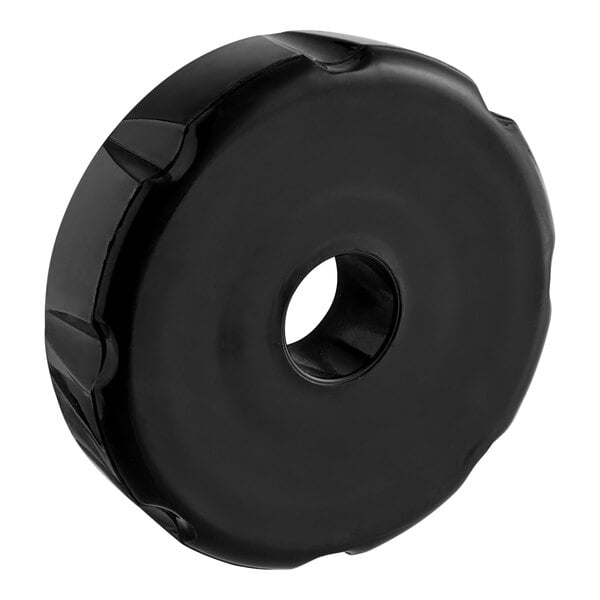 A black circular faucet bonnet with a hole.