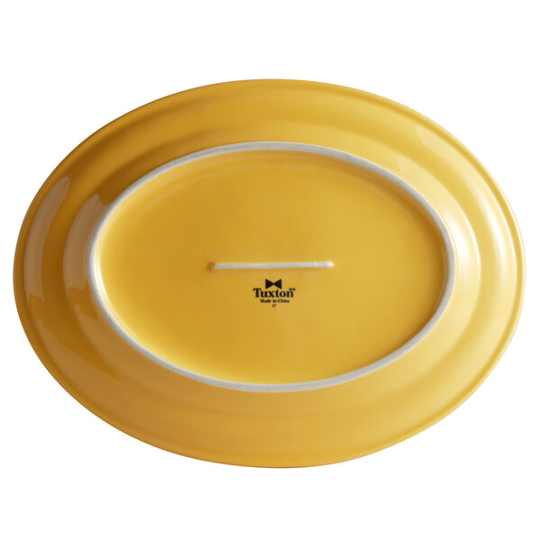 A yellow oval china platter with a white border.