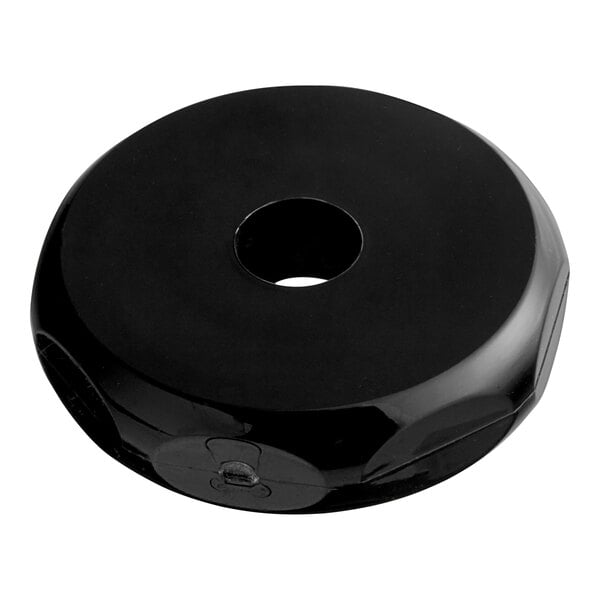 A black circular plastic Bunn faucet bonnet with a hole in it.