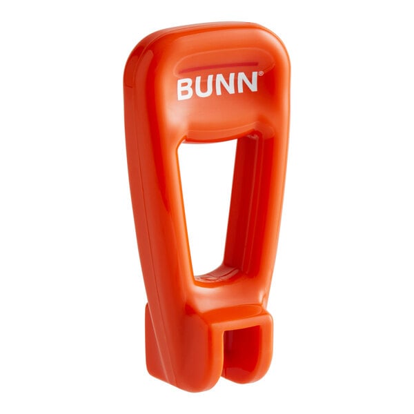 A close-up of an orange Bunn faucet handle.